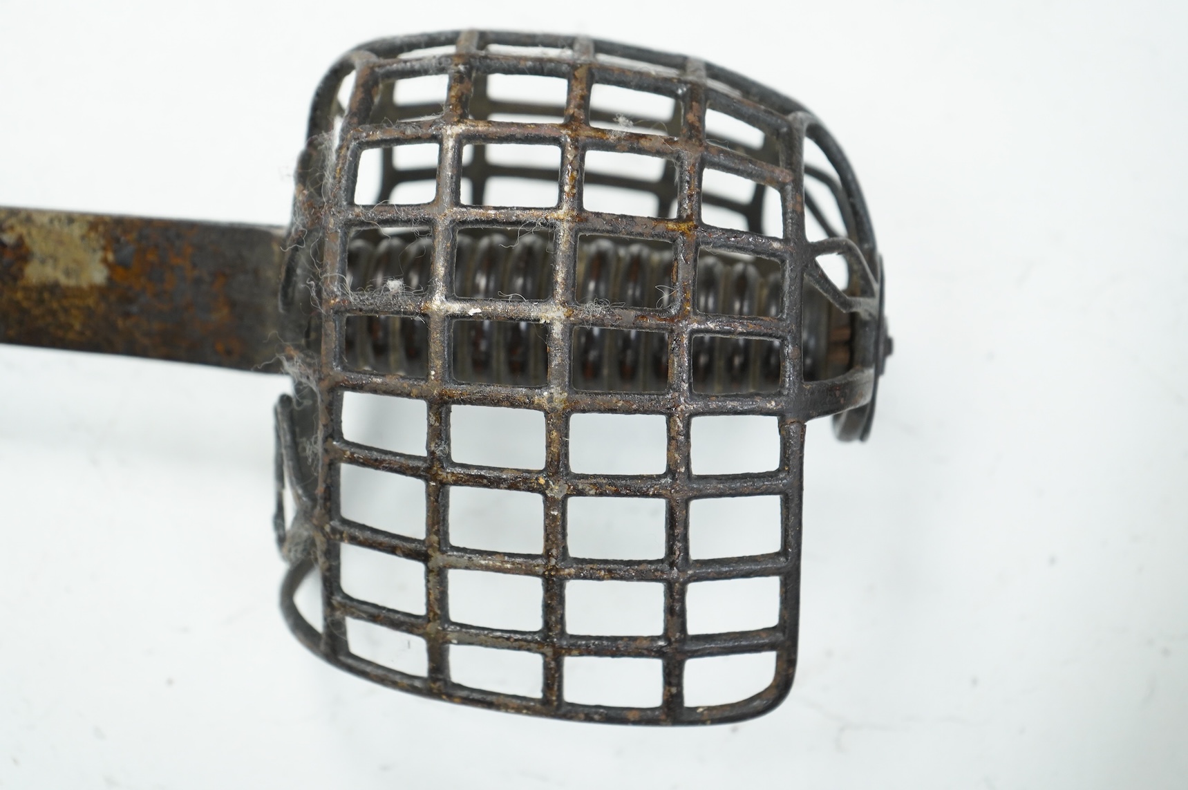 A basket hilted backsword of c.1750, with single edge blade cut with a pair of fullers, three-quarter basket guard comprising many rectangular openings, blade 90.5cm